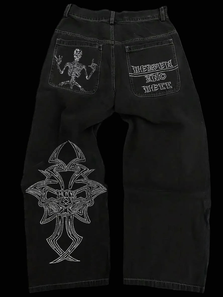 Black jeans with white embroidered designs on a white background